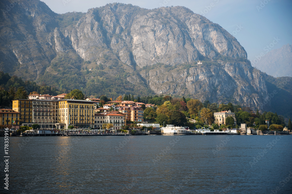 A small cozy town in Italy near Lake Como against the background of the huge Alpine mountains