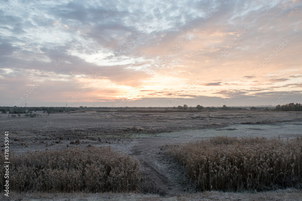 Landscapes on the outskirts of the village. The first hoarfrost. Sunrise.