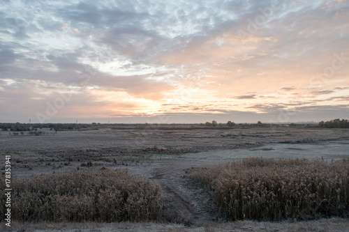 Landscapes on the outskirts of the village. The first hoarfrost. Sunrise.