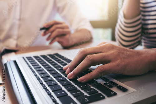 Two businessmen at work, Business crew working with new startup financial project plan,man and woman discussion information with laptop and digital tablet in a modern business lounge,Selective Focus