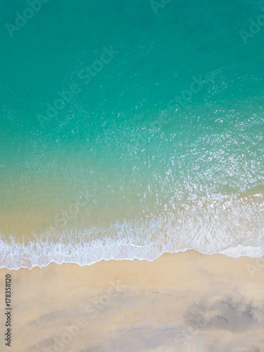 Beach top view with wave foam