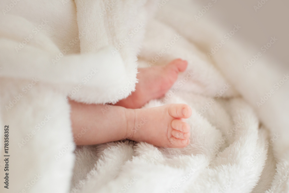 two small baby legs. Baby in a towel. two small baby legs. Baby in a towel.