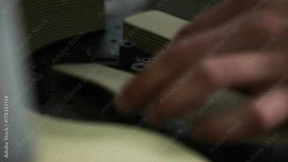 Worker make laser marking of soles of shoes Worker make laser marking of soles of shoes