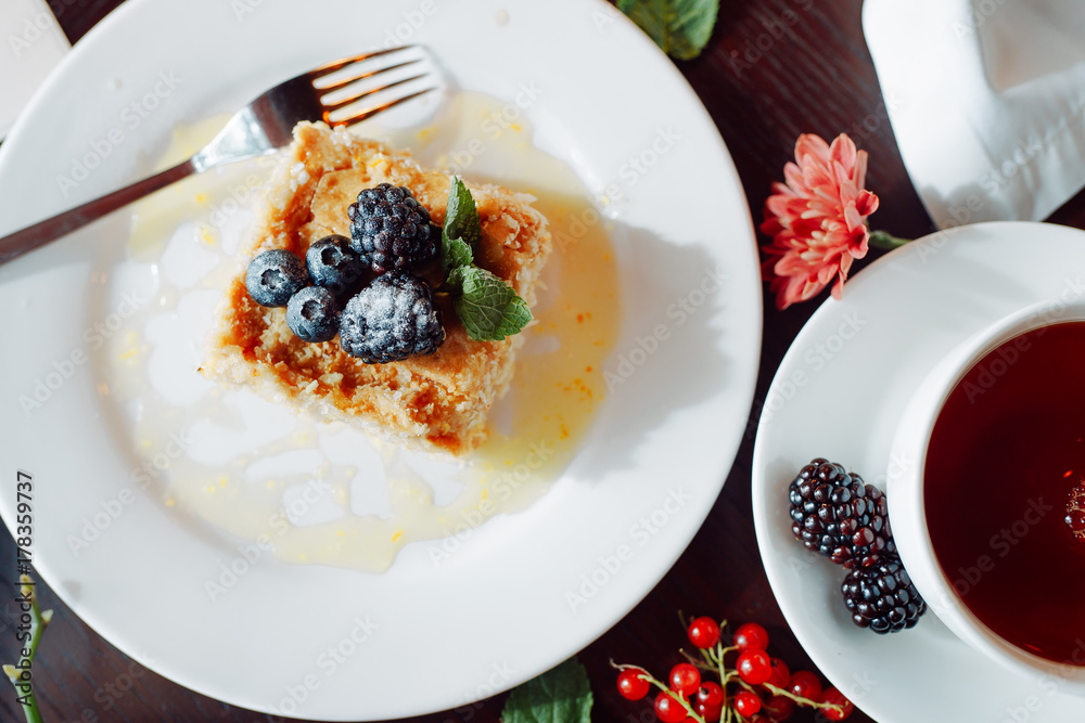 a piece of delicious Napoleon, decorated with blackberries and blueberries a piece of delicious Napoleon, decorated with blackberries and blueberries