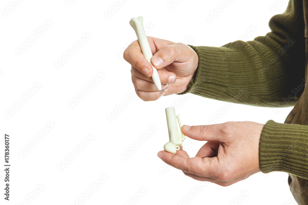 Hands holding ballpoint pen in form of stone Hands holding ballpoint pen in form of stone