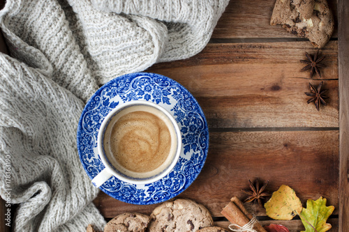 coffee in a vintage cup, on a wooden background with autumn decor and biscuit biscuits