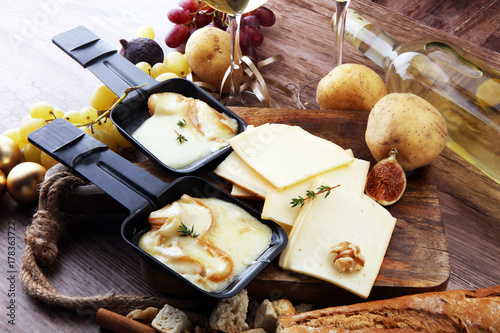 Photography Delicious traditional Swiss melted raclette cheese on diced boiled or baked pota