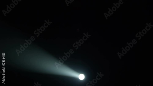 Realistic footage of stage light flashing rays spotlights through smoke. Great as a natural stage background for different projects!!! photo