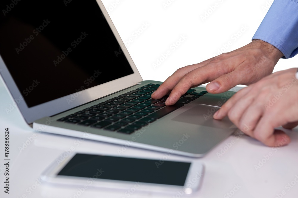 Cropped image of businessman using laptop computer Cropped image of businessman using laptop computer