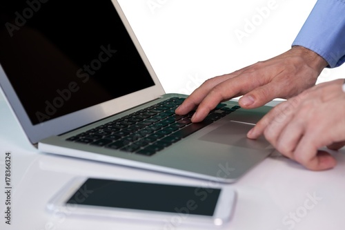 Cropped image of businessman using laptop computer