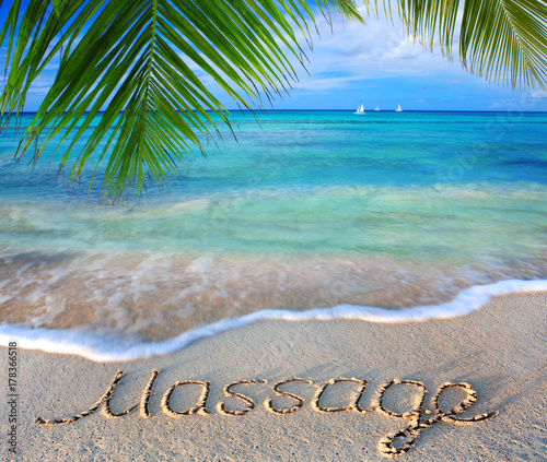 Fototapeta Naklejka Na Ścianę i Meble -  Massage concept written on sand.