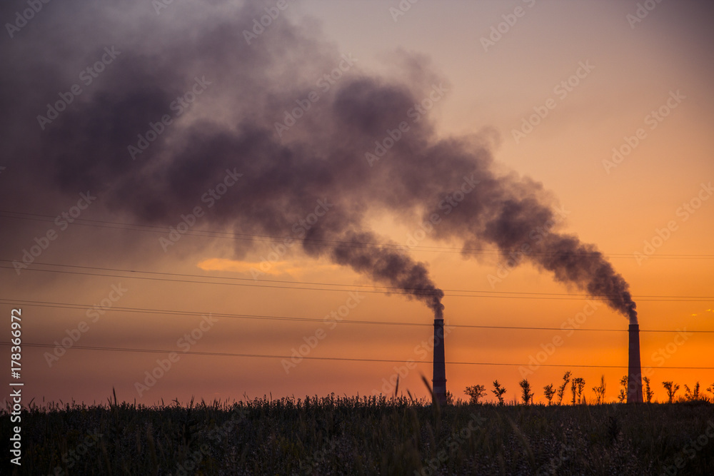 Industrial smoke from chimney at sunset, steppe near Almaty, Kazakhstan