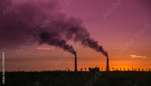 Industrial smoke from chimney at sunset, steppe near Almaty, Kazakhstan