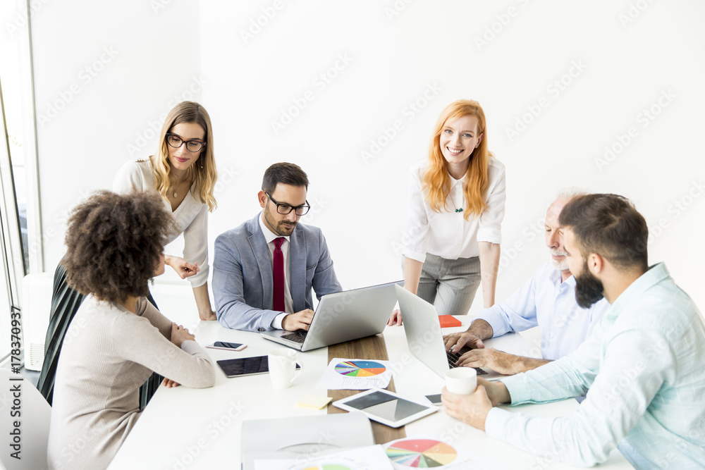 Joyful multiracial business team at work in modern office Joyful multiracial business team at work in modern office