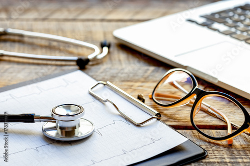 doctor workplace with a stethoscope at wooden table