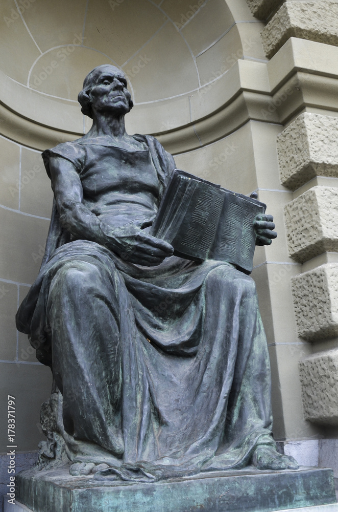 Sculpture  holding a book at the entrance of the government building in Switzerland
