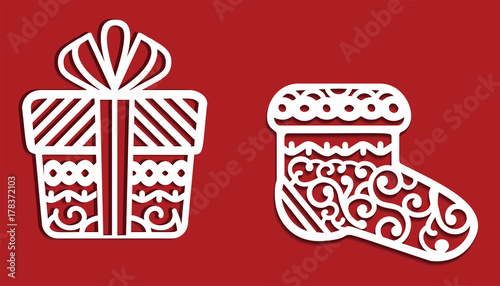 White Christmas decorations on red background: gift and sock. May use it for cutting