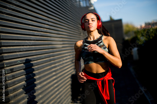 Active young beautiful woman running in urban enviroment