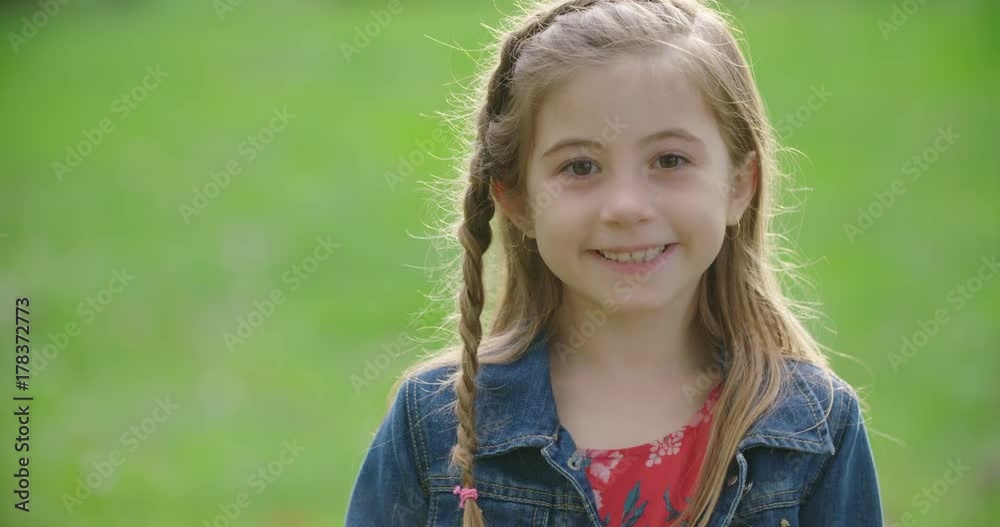 Young Girl Serious then Smiles at Camera Close Up. a close up view of a girl smiling at the camera and playing with her hair. Slow motion
Young Girl Serious then Smiles at Camera Close Up. a close up view of a girl smiling at the camera and playing with her hair. Slow motion