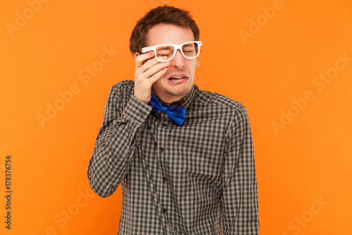 Fényképezés Emotional man crying and wipes away tears.