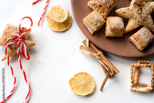 Christmas cookies, Christmas spices and dried orange slices on white background photo