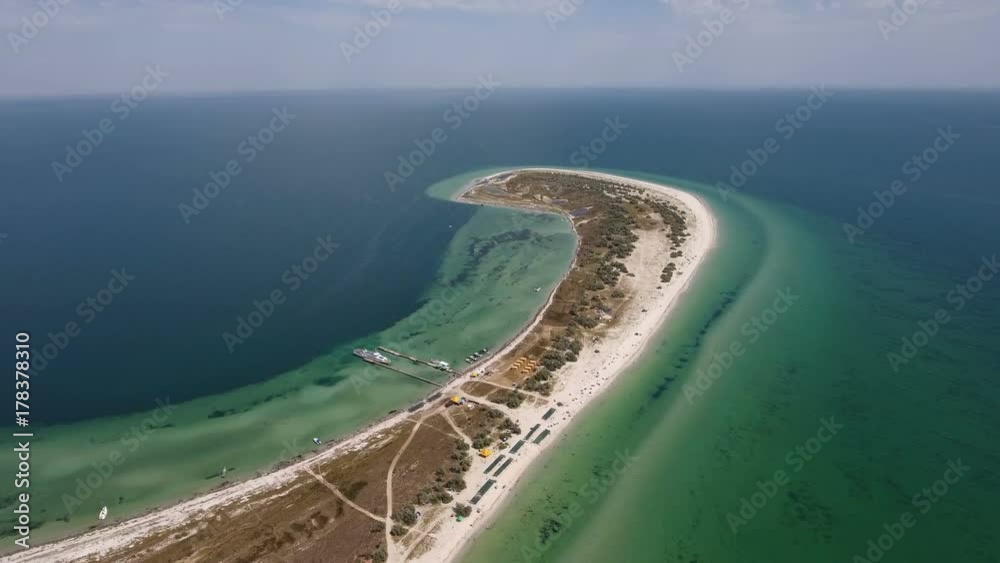 A splendid bird`s eye view of a curvy seacoast of Dzharylhach island in the Black Sea in summer. It is covered with sand and multicolored weeds and wetland. The landscape looks fine A splendid bird`s eye view of a curvy seacoast of Dzharylhach island in the Black Sea in summer. It is covered with sand and multicolored weeds and wetland. The landscape looks fine