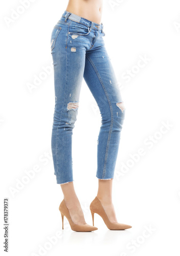 Slim and sexy female legs in jeans isolated on white.