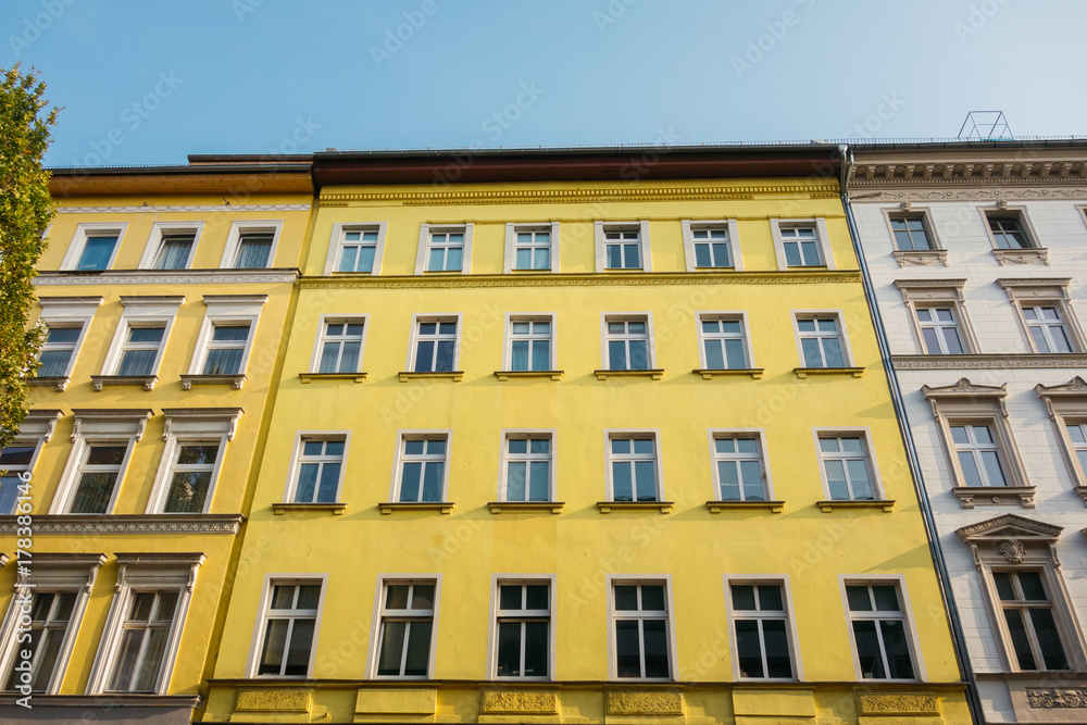 yellow facade of apartment building in low angle view