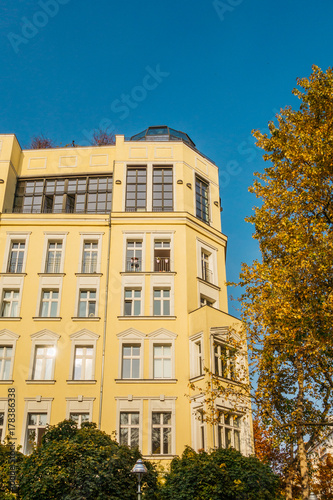 yellow corner building next to an autumn tree © Robert Herhold