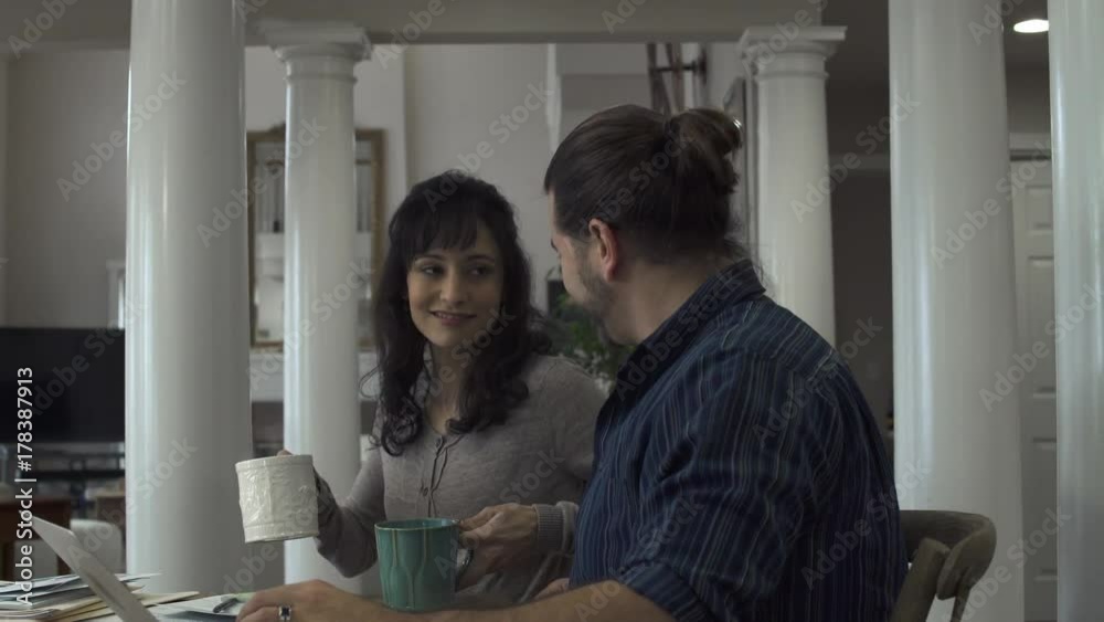Tracking shot of a woman bringing a drink to her husband Tracking shot of a woman bringing a drink to her husband