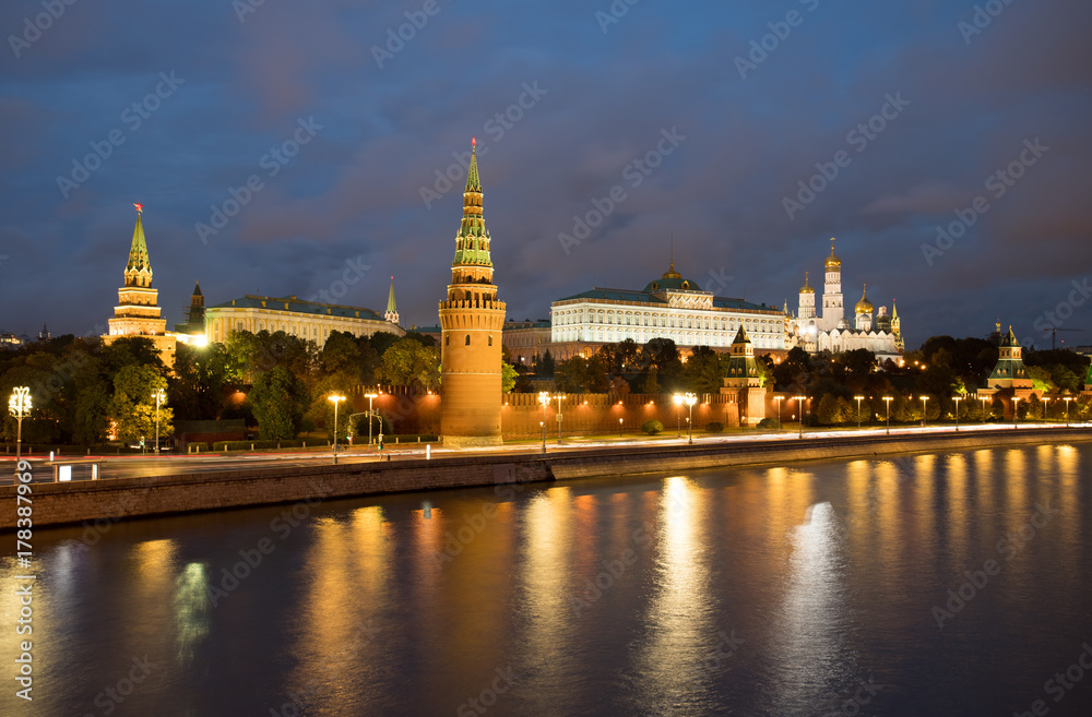Moscow, Russia. Beautiful View Of Moscow Kremlin On Banks Of Moscow River With Reflection On Background Of Blue Hour With Clouds At Evening.