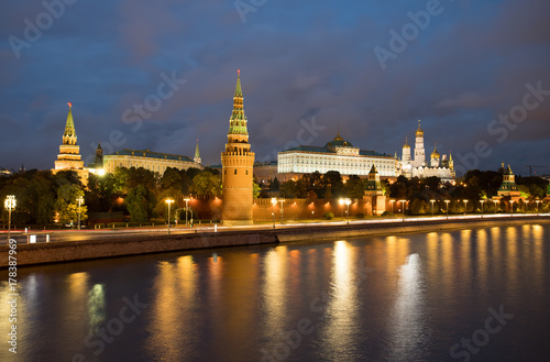 Moscow, Russia. Beautiful View Of Moscow Kremlin On Banks Of Moscow River With Reflection On Background Of Blue Hour With Clouds At Evening.