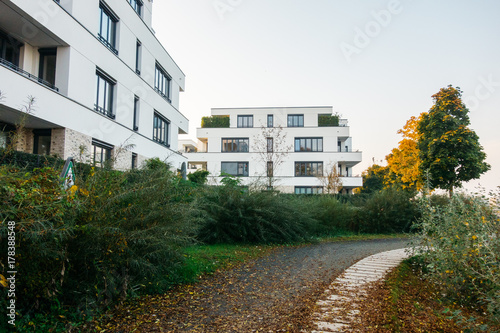 white modern apartment houses with small foot path in the middle