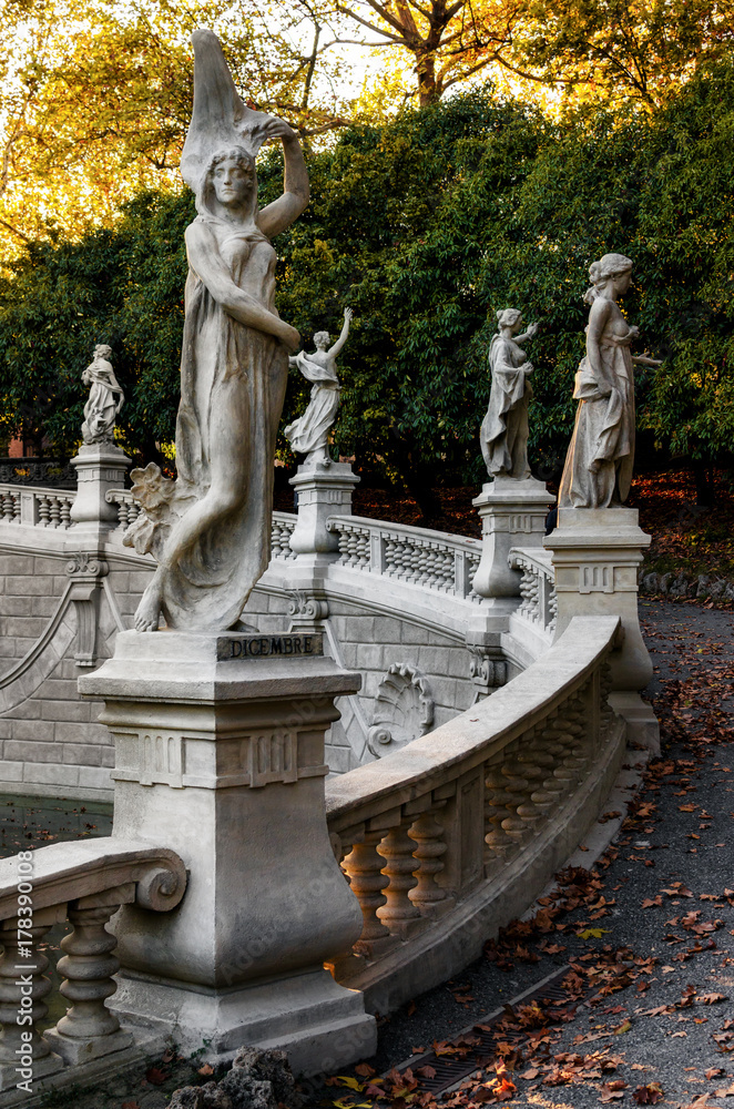 Obraz premium Autumn sunset view of the fountain of the twelve months, build in Valentino public park during the 1898 great exhibition of Turin (Piedmont, Italy). Detail of the statue of december