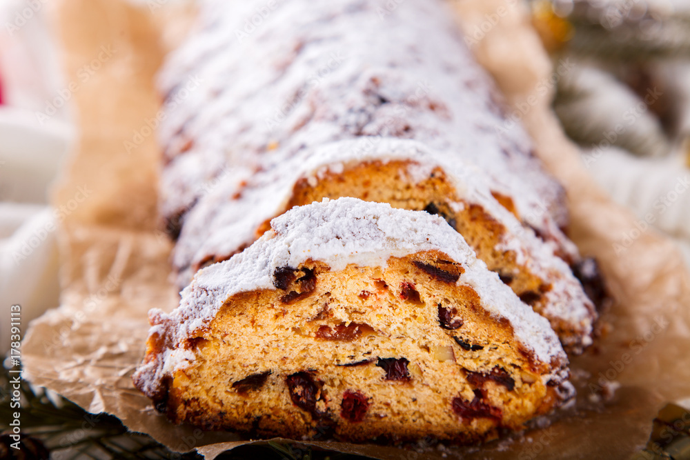 Dresdner Stollen is a Traditional German Cake with raisins on a light knitted background.Gift for Christmas.Vintage style.Fruit cake for the Holiday.
