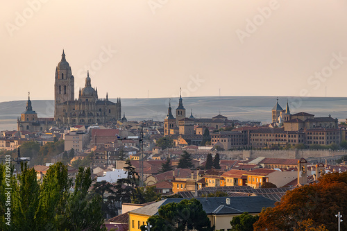 Panoramic view of medieval city of Segovia at sunset with the wall surrounding the old city, Spain