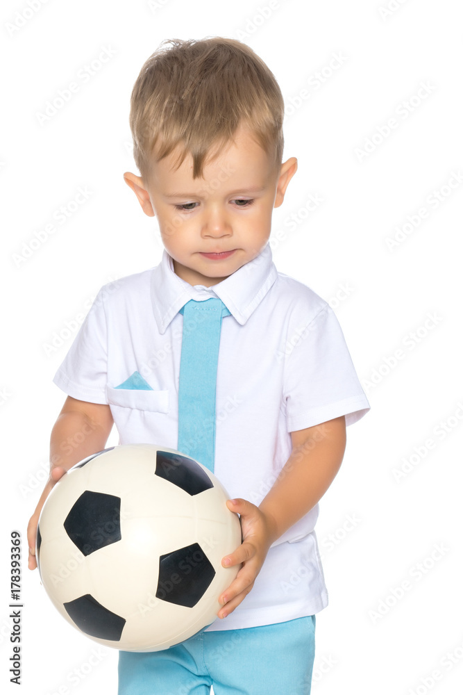 A little boy is playing with a ball. A little boy is playing with a ball.