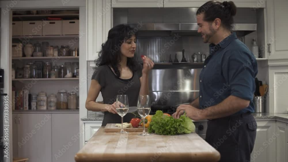 Push-in shot of a couple cooking together Push-in shot of a couple cooking together