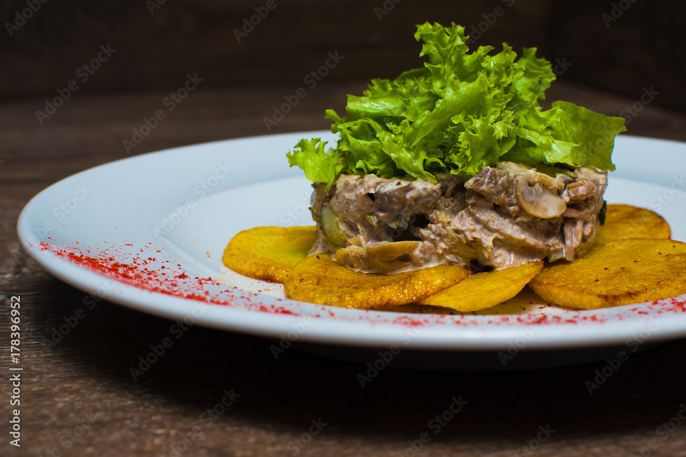 fried potatoes with salad on a plate