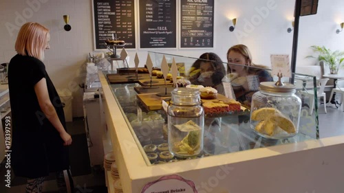 Medium shot of two women in a pastry shop