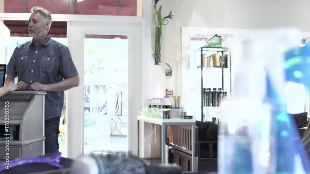 Medium shot of a man arriving at a hair salon Medium shot of a man arriving at a hair salon