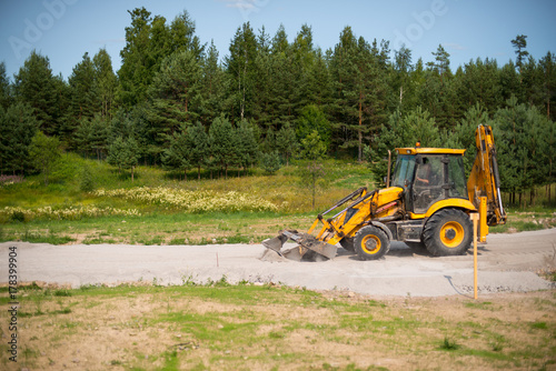 Bild auf Leinwand Wheel loader Excavator unloading sand with water during earth moving works at co