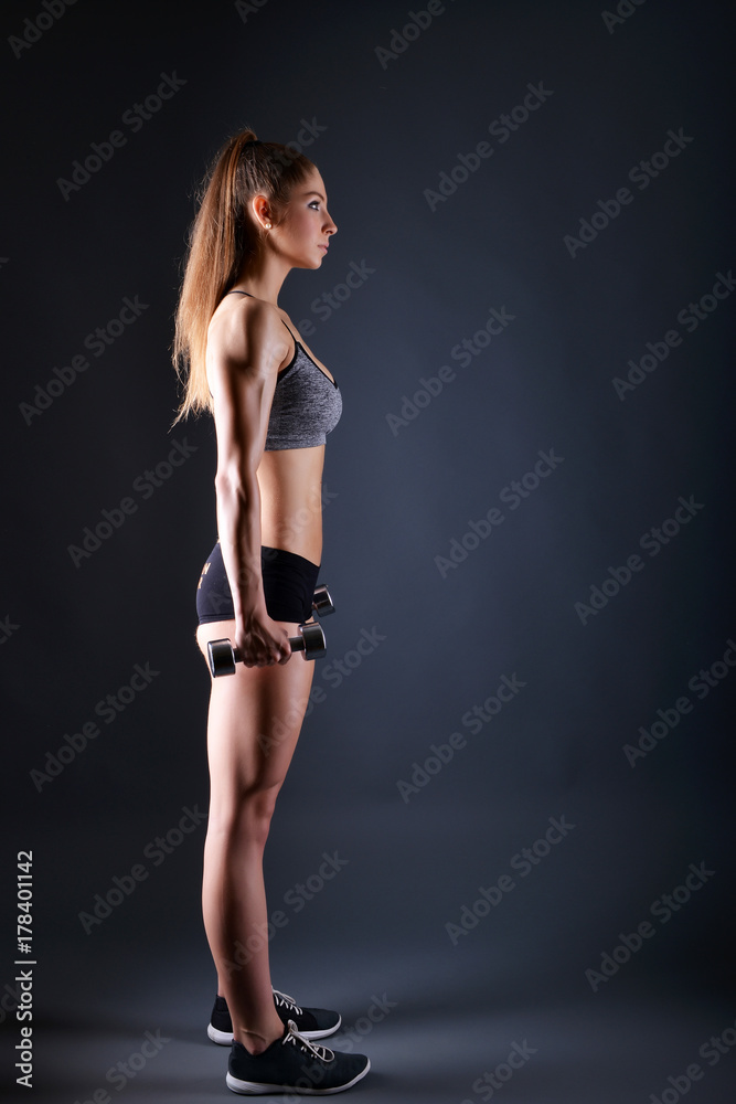 Beautiful young sporty sexy woman showing muscle Beautiful young sporty sexy woman showing muscle