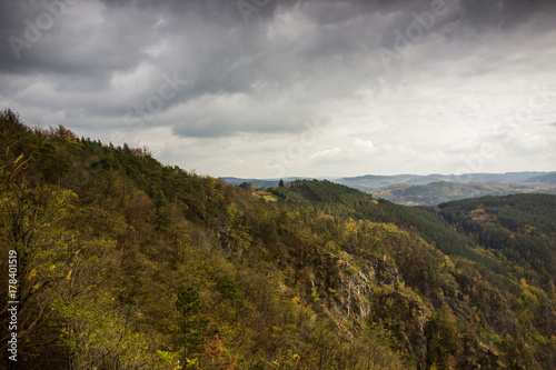 Cloudy sky over autumn forest