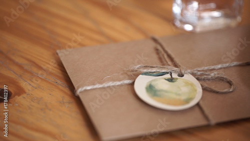 Vintage package tied up with string. Close up envelope sealed. Envelope of kraft paper tied with twine, with a red wax seal, close up.
