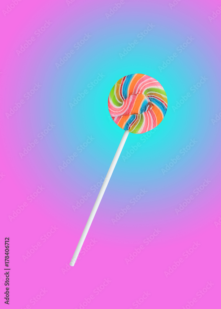 Colorful rainbow lollipop swirl on stick isolated on sweet pastel color background. Colorful rainbow lollipop swirl on stick isolated on sweet pastel color background.