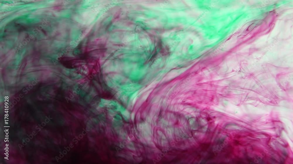 Inks of red and green color dissolve in clear water. Slow motion Inks of red and green color dissolve in clear water. Slow motion