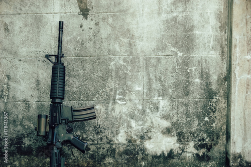 M4A1 (AR-15), M-16 assault rifle gun for the American military is placed beside the old wall.