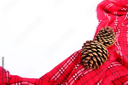 Red table cloth with pine cone and copy space