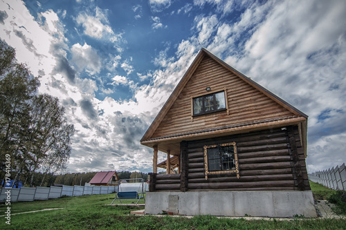 Obraz na płótnie Small rural house in cloudy summer day w salonie